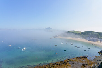 Looking across a foggy Porthdinllaen bay form high on the cliffs.