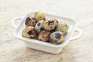 Raw quail eggs heap in the bowl