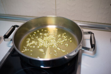 Cooking pot with oil and diced garlic