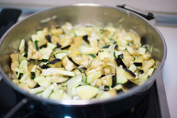 Cooking pan heating diced vegetables