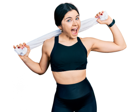 Young brunette woman with blue eyes wearing sportswear and towel celebrating crazy and amazed for success with open eyes screaming excited.