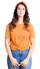 Fototapeta premium Beautiful young brunette woman wearing casual clothes with serious expression on face. simple and natural looking at the camera.