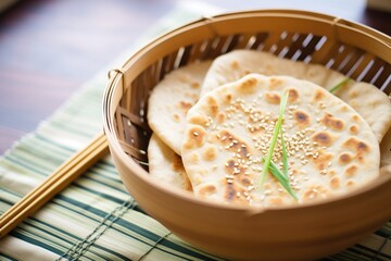 close-up of naan with sesame seeds in a bamboo basket