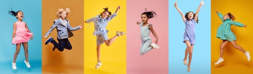 Collage. Children, boys and girls having fun, laughing, jumping over multicolored background....