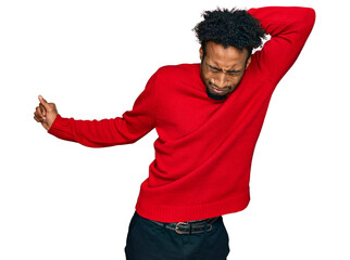 Young african american man with beard wearing casual winter sweater stretching back, tired and relaxed, sleepy and yawning for early morning