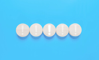 wood block shows an icon important. points attention. concept of signal alert, caution, or idea. the information exclamation mark in business and security