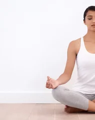  Woman, meditation and spiritual in a home with mockup space and yoga for balance and mindfulness. Morning, wellness and zen in house on floor to relax for calm breathing and peace in lotus position © peopleimages.com