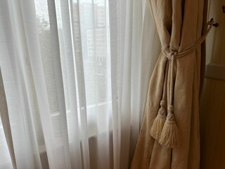 Window with beautiful beige curtain indoors. Interior element