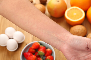 Food allergy. Woman holding hand over products on table, closeup
