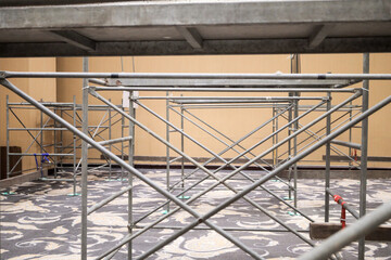 Scaffolding construction. Steeplejacks on a scaffold in the room.