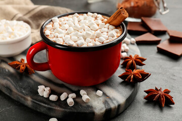 Tasty hot chocolate with marshmallows on dark textured table, closeup