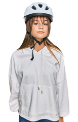 Teenager caucasian girl wearing bike helmet depressed and worry for distress, crying angry and afraid. sad expression.