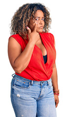 Young african american plus size woman wearing casual style with sleeveless shirt pointing to the eye watching you gesture, suspicious expression