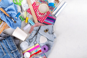 DIY upcycling ideas and materials background. Sustainable hobby with handmade, ecology creative reusable hand made with plastic bottles, metal cans, old jeans, fabrics, glass containers, top view