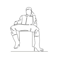 a man sits on a chair in women's boots