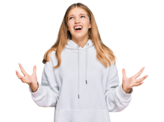 Beautiful young caucasian girl wearing casual sweatshirt crazy and mad shouting and yelling with aggressive expression and arms raised. frustration concept.