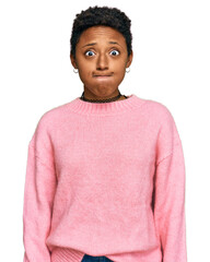 Young african american woman wearing casual clothes puffing cheeks with funny face. mouth inflated...