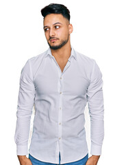 Young arab man wearing casual clothes smiling looking to the side and staring away thinking.