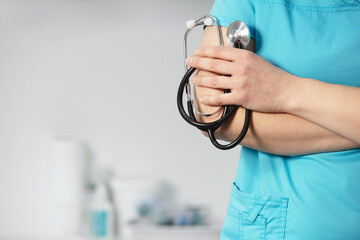 Doctor holds his stethoscope to insinuate that it's time for a check up, professional emergency...