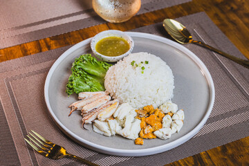 Boiled chicken rice mixed with crab meat on a wooden table
