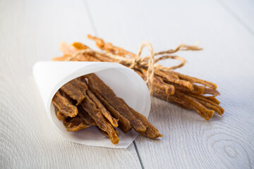 A handful of dried chicken meat, marinated with spices.