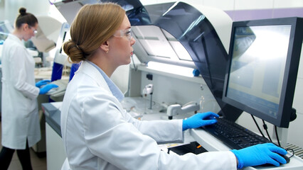 A medical research laboratory with a diverse team of biochemical scientists working with computers and modern medical technologies. Development of high-tech equipment for medicines.