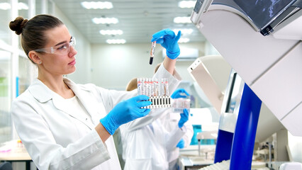 A medical research laboratory with a diverse team of biochemical scientists working with computers and modern medical technologies. Development of high-tech equipment for medicines.