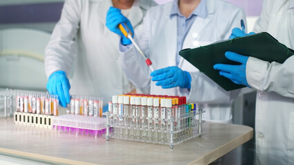 Modern loborothyria. The scientist examines the test tubes and takes notes. Organized test tubes with scientific samples and substances in them, intended for scientific research.