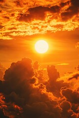 Fototapeta premium A beautiful sunset as the sun sets over the clouds in the sky. This image can be used to depict the end of the day, peacefulness, and the beauty of nature