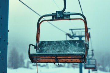 A picture of a snow covered ski lift with a chairlift in the background. This image can be used to depict winter sports and activities
