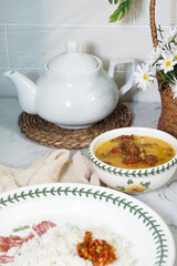 A bowl of creamy butter milk chicken. Selective focus. Overexposed.