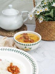 A bowl of creamy butter milk chicken. Selective focus. Overexposed.