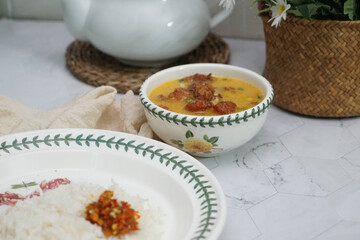 A bowl of creamy butter milk chicken. Selective focus. Overexposed.