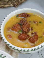 A bowl of creamy butter milk chicken. Selective focus. Overexposed.