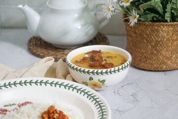 A bowl of creamy butter milk chicken. Selective focus. Overexposed.