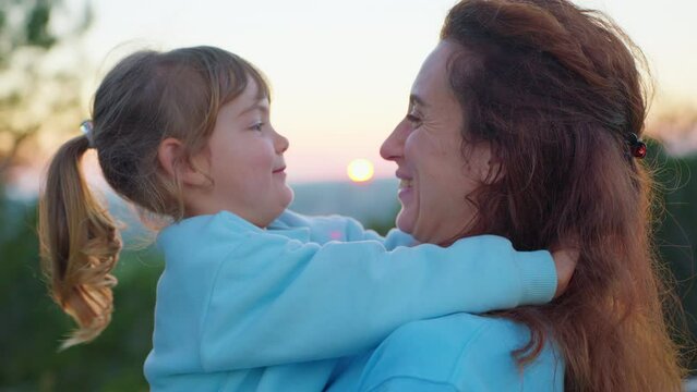 Happy cute affectionate adopted little kid girl hugging foster care parent mother with eyes closed, adorable small child daughter embrace mum cuddling enjoy tender sweet moment concept, close up view