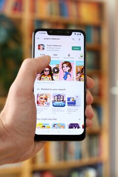 WARSAW, POLAND - JANUARY 29, 2021: User installing Project Makeover mobile freemium game on an Android OS, Xiaomi brand smart phone.