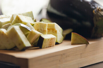 Culinary Precision: Cut Eggplants on Wooden Board Close-Up