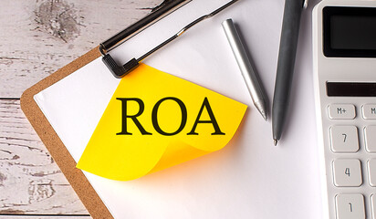 ROA word on yellow sticky with calculator, pen and clipboard