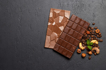 Two chocolate bars on stone background