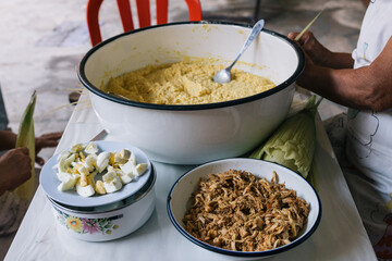 Ingredients to prepare Humitas, traditional Peruvian food, crushed corn, chicken meat and boiled egg