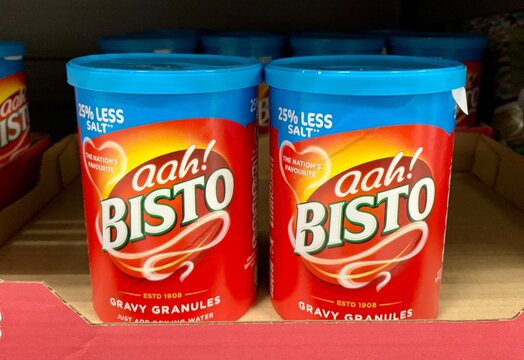 Essex, UK - January 15, 2024: Cardboard tubs with plastic lids of Bisto gravy granules on sale in a UK supermarket. 