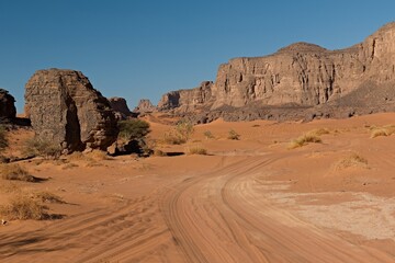 View of the Tadrart Rouge rocky mountain range in Tassili n Ajjer National Park. Sahara desert, Algeria, Africa.