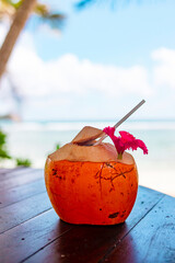 coconut in sunglasses on table on the background of the sea, the concept of summer holidays and vacations, funny photo