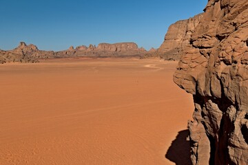 View of Tamezguida rock formation in Tadrart Rouge rocky mountain range in Tassili n Ajjer National Park. Sahara desert, Algeria, Africa.