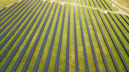 Obraz premium top view of solar panels and green forest at sun. ecology concept. view from above, drone shot