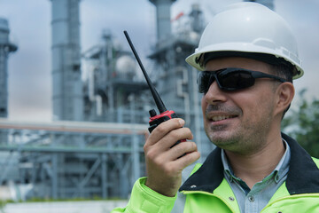 worker talking on radio communication. Man using radio communication  working at power plant ...