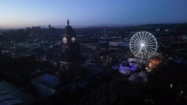 4K: Aerial Drone Video of Lancaster Ferris Wheel & Ice Rink at Christmas, with Town Hall Clock in foreground. Lancashire, UK. Circle. Stock Video Clip Footage