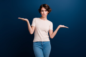 Photo portrait of pretty young girl irritated palms compare empty space dressed stylish white outfit isolated on dark blue color background