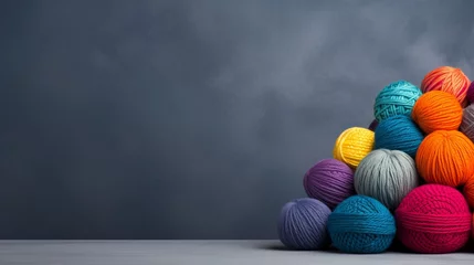 Foto op Aluminium Rainbow wool yarn balls on gray background with ample text space for design or advertising. © Ilja